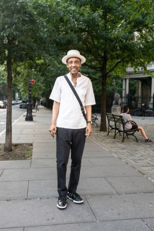 Henry Threadgill stands on a street with trees.