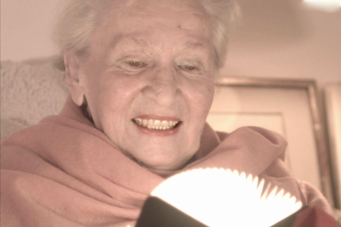 Composer Éliane Radigue contemplates a gadget that looks like an enlightened book