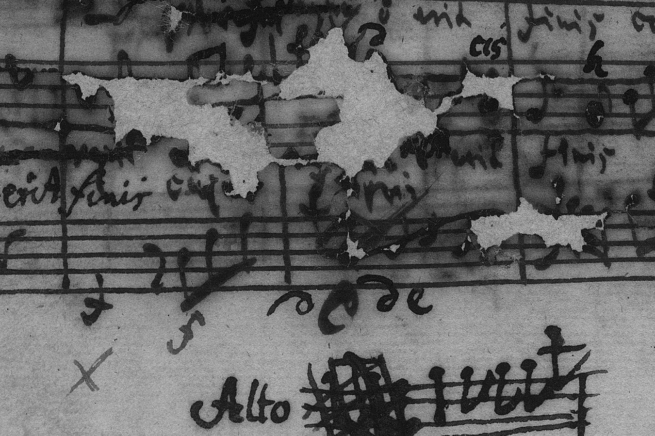A written sheet of music, slightly damaged and with handwritten additions