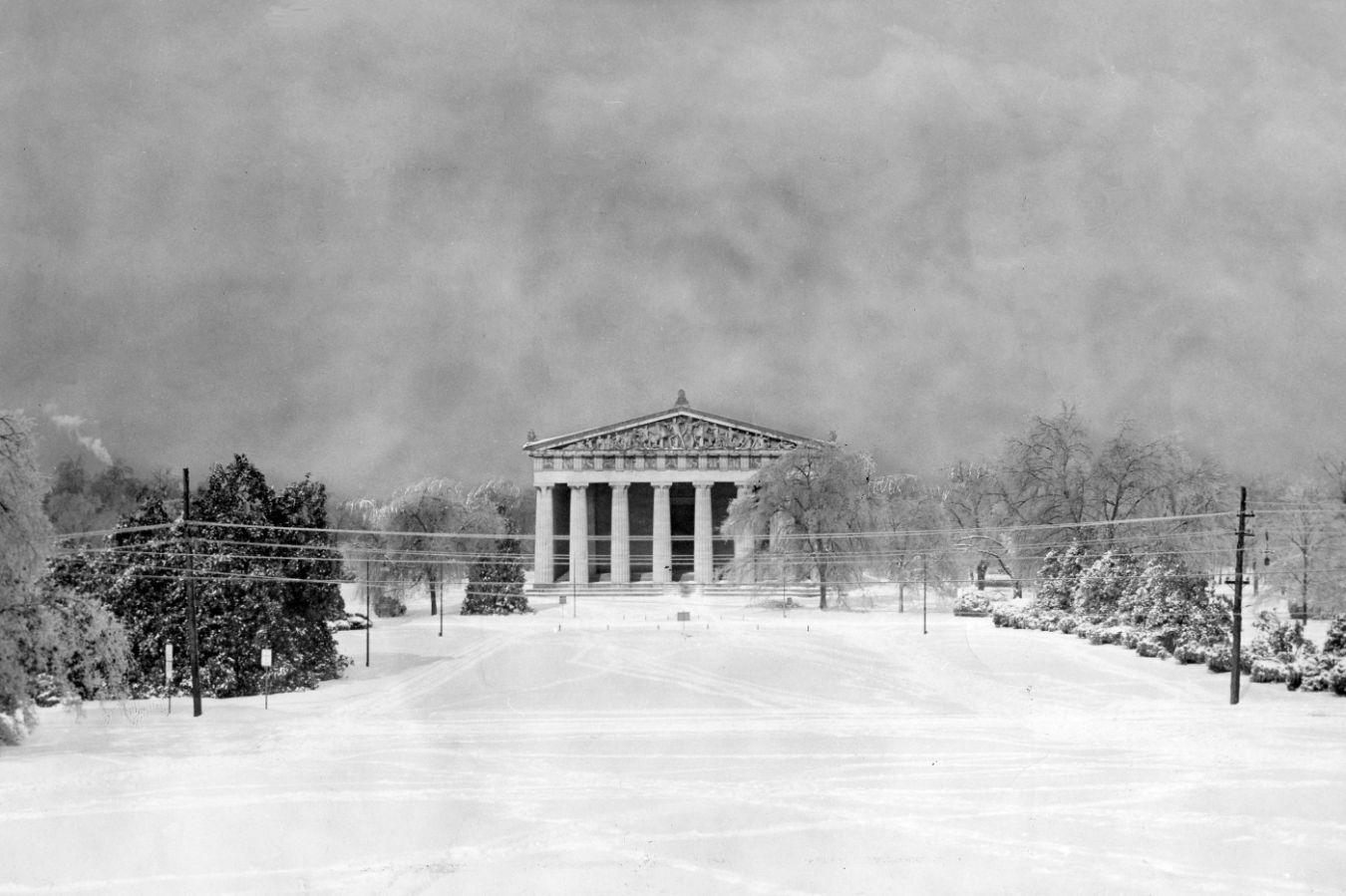 Snow-covered park with temple building in the style of Greek antiquity