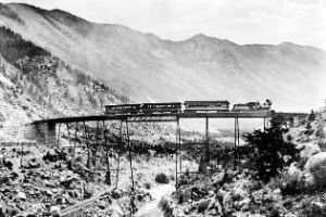 Railway in the high mountains on a bridge over a river