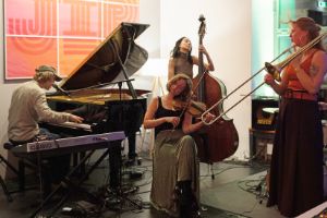 Four musicians play together. They are feeling the music.