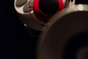 Close-up of a white, round speaker with pink detail.