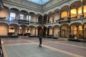 A person standing in the empty Atrium at Gropius Bau