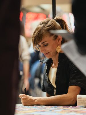 Photograph with Alexandra Klobouk, signing prints of the hidden object poster.