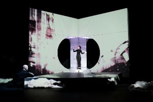 A person in a stage set that works with geometry and projections